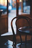 A bentwood chair next to wooden table in a bar