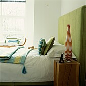 White bedroom with colourful accessories