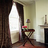 Large window with heavy curtains in a living room