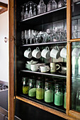 Crockery and glassware in vintage cupboard