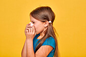Girl blowing her nose