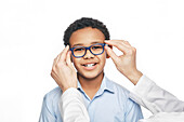 Young boy trying on glasses