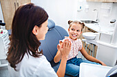 Young girl high-fiving dentist