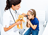Girl playing with otoscope
