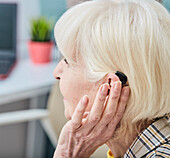 Senior woman with hearing aid