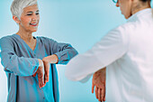 Doctor checking a senior woman for carpal tunnel syndrome