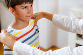 Pediatrician checking posture of a boy