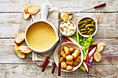 Classic cheese fondue with mixed pickles
