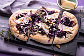 Red cabbage flatbread with onions, apples, blueberries, and tofu