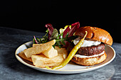 Beef burger with chunky chips and pickle