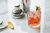 An Old Fashioned Cocktail with rosemary and orange peel