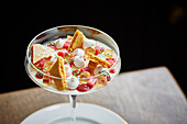 Rhubarb dessert with honeycomb and meringue in a stemmed glass