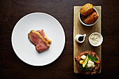 Roast beef with side dishes on a board