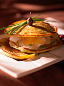 Blini with haddock, potatoes and olives
