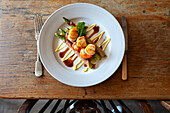 Scallops on asparagus wrapped in ham with balsamic vinegar and mayonnaise