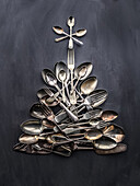 Vintage cutlery laid in the shape of a Christmas tree