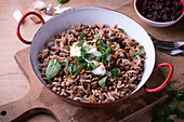 Lentil and rice pan with mint, sultanas, fried onions and soy yoghurt