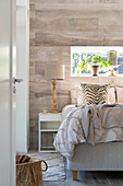 Brightly decorated bedroom with large bed and cushions with zebra pattern