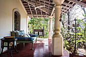 Colonial-style terrace with day bed and hanging swing