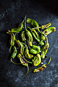 Blistered Shishito Peppers on Dark Background