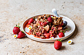 Strawberry Rhubarb Crisp on a plate with a spoon