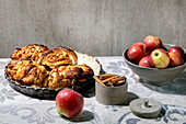 Sweet apple sticky cinnamon rolls buns in round baking tray