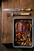 Classic holiday dish roasted glazed duck with apples in baking tray