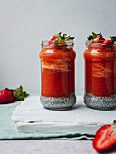 Strawberry smoothie with a yellow flower garnish