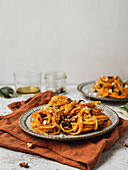 Pumpkin noodles with seeds served on plate of table for lunch