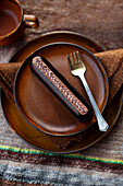 Brown dessert plate with chocolate cake and coffee cup