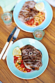 BBQ lamb steaks with garlicky white beans
