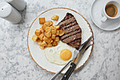 Flat steak with eggs and fried potatoes