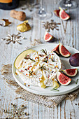 Cooked camembert with figs in a Christmas setting