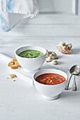 Tomato and bean soup, and pea soup in soup bowls