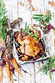 Roasted chicken with beets, carrots, and herbs