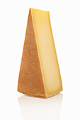 A piece of Gruyere against a white background