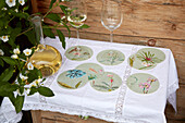 Wine glasses, carafe and coasters with floral motifs