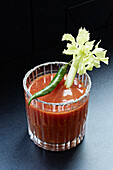 Bloody mary served with a fresh green chilli