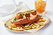 Spicy meatball sub sandwich served with chips