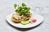 An English muffin with crabmeat and watercress salad