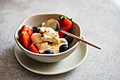 Summer ice cream dessert served with strawberries and blueberries