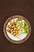 Chicken and vegetable skewers and salad garnish with boiled eggs