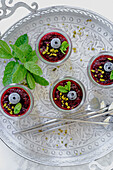Coconut semolina pudding with berries and pistachios