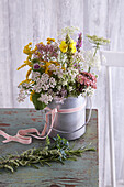 A bouquet of wild flowers in a zinc bucket