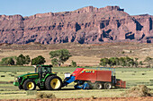Rancher baling hay with a tractor and baler