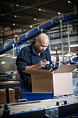 Worker using a barcode reader in a warehouse