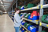Worker scanning items in a distribution centre