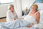 Patient talking to a family member in the nursing ward