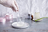 Making Aloe gel - mixing ingredients in medical glass beaker