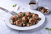 Vegan bread dumplings with mushrooms and red wine vegetable sauce